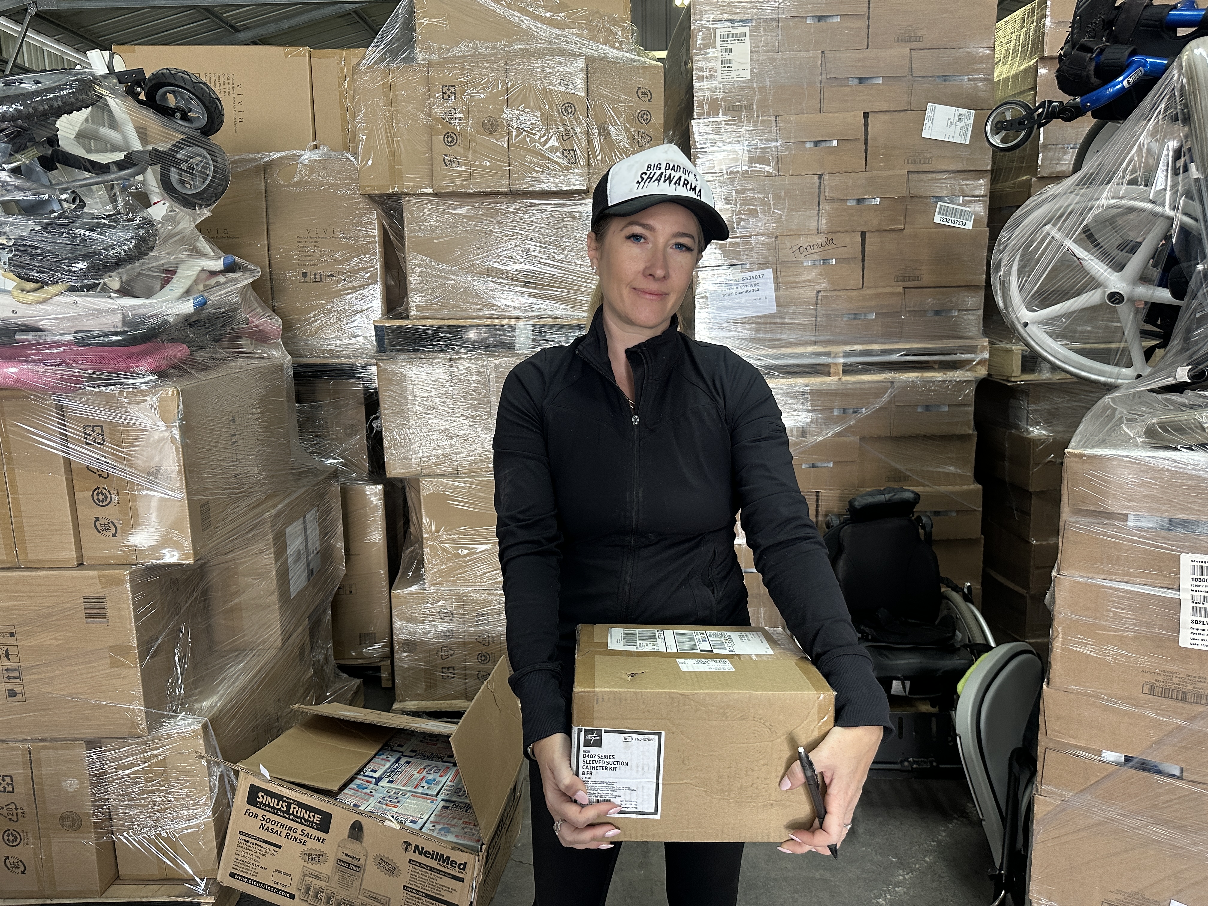 Kate Hamias holds a box of medical supplies
